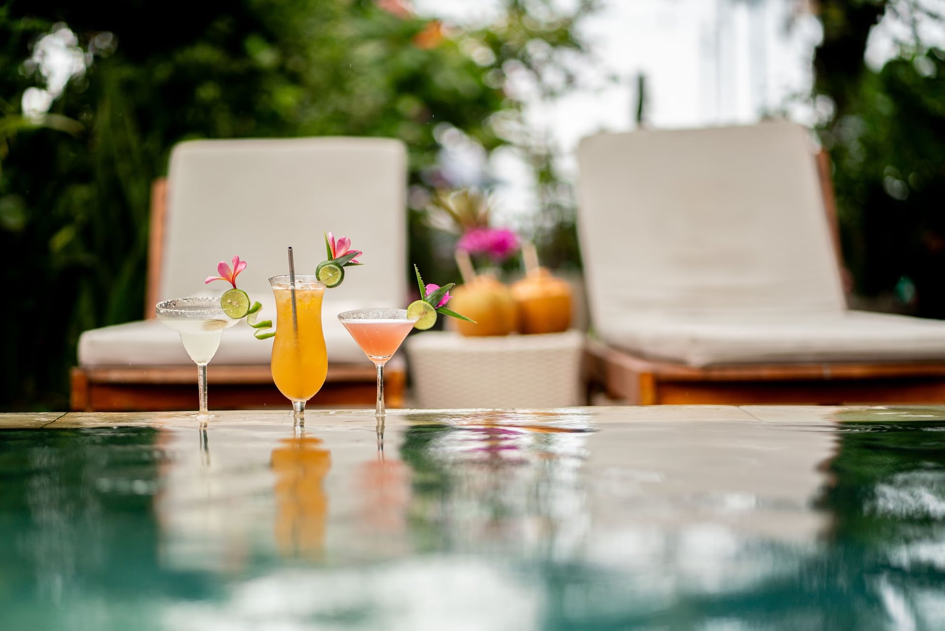 Sunlight shimmers on our freshwater pool, surrounded by lush tropical…